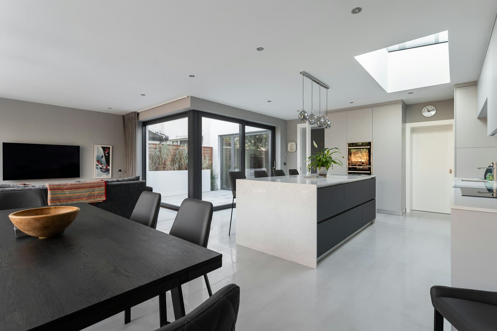 Open-plan kitchen and dining extension with a roof light and sliding doors to the garden