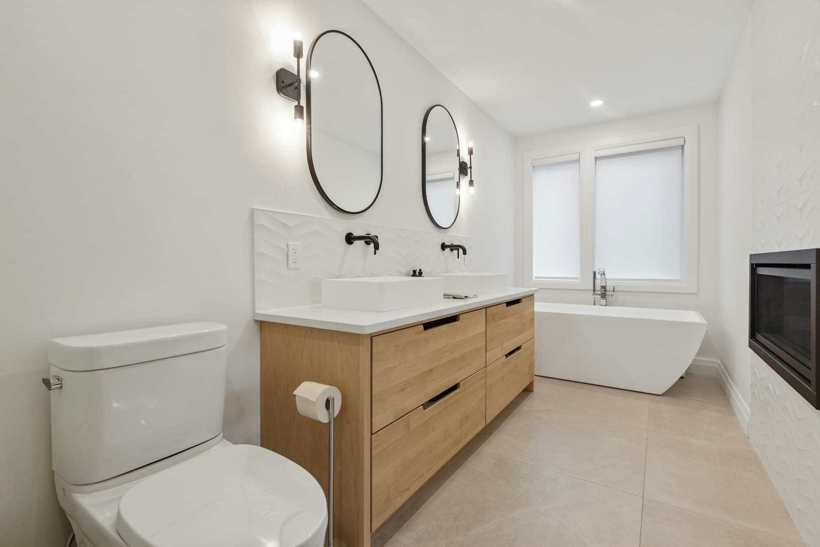 Bathroom with double basins on an oak vanity and a freestanding bath
